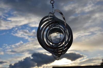 Low angle view of hanging light against sky