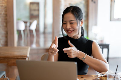 Young woman using laptop at table