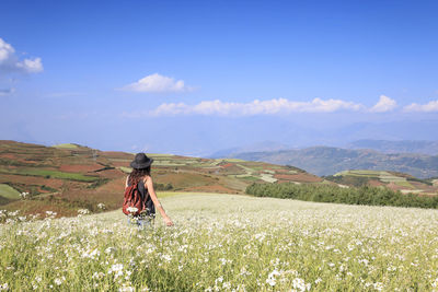 Rear view of man standing on landscape against mountain