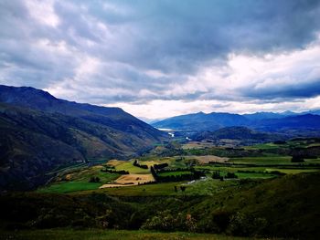 Scenic view of landscape and mountains against sky