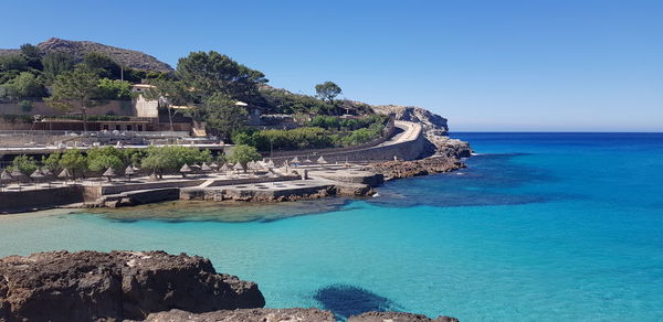 Scenic view of sea against clear blue sky