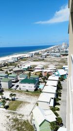 High angle view of sea and buildings against sky