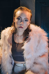 Portrait of young woman standing outdoors