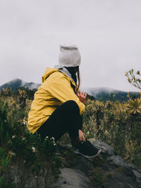 Rear view of man on yellow land against sky