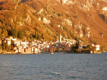 Scenic view of sea by buildings in town