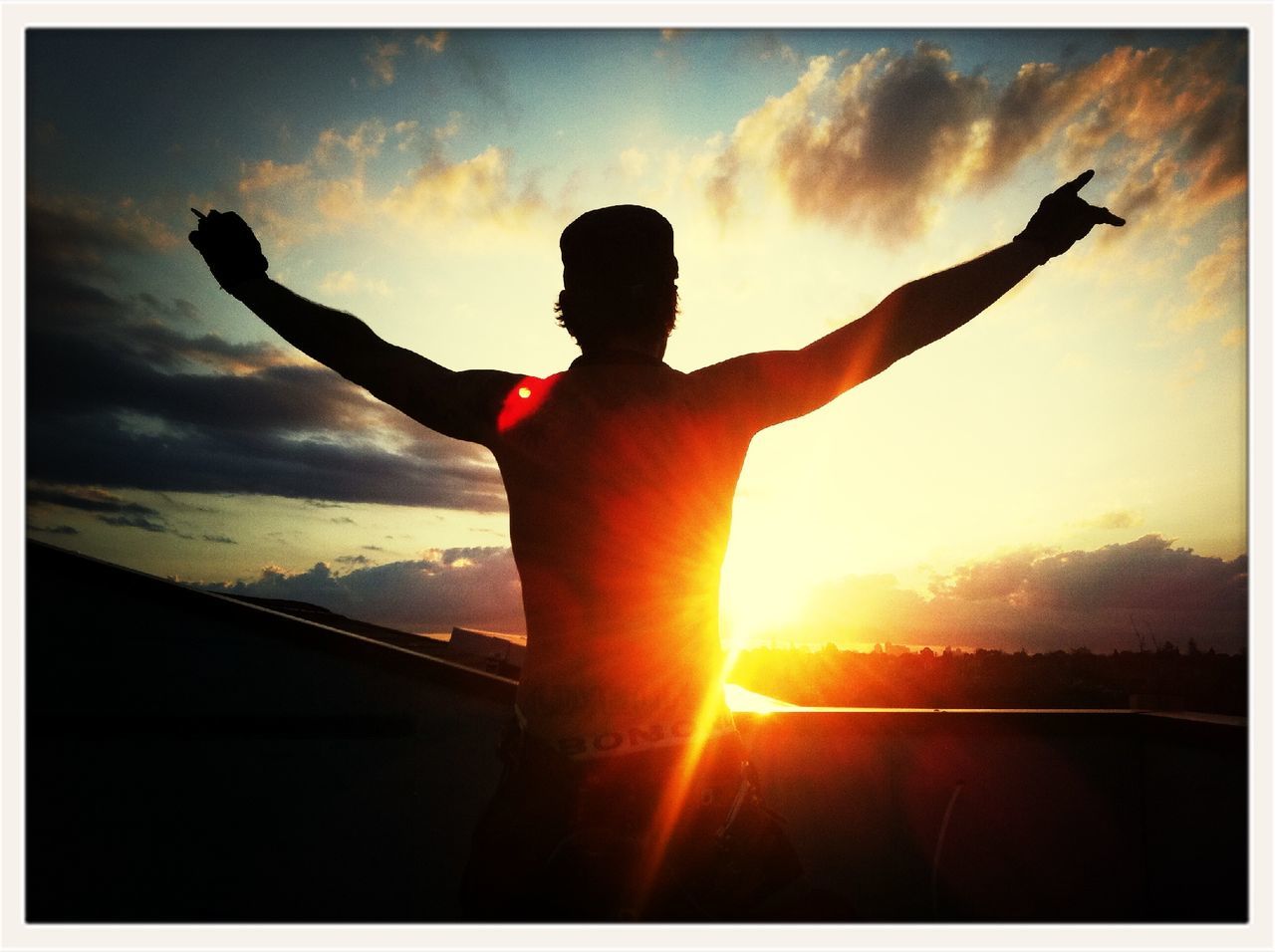 sunset, transfer print, silhouette, sky, sun, auto post production filter, lifestyles, orange color, cloud - sky, leisure activity, sunbeam, cloud, sunlight, low angle view, full length, back lit, mid-air, men