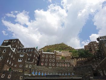 Low angle view of buildings in city against sky