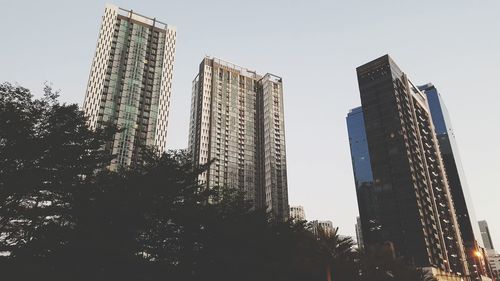 Low angle view of skyscrapers against clear sky