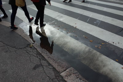 Low section of people walking on road