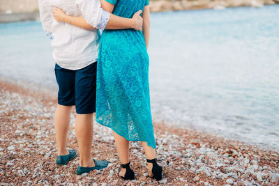 Low section of woman standing on beach