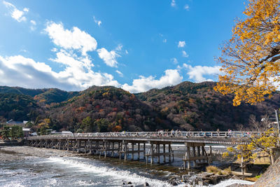 Bridge over mountain against sky during autumn