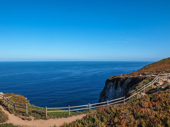 Scenic view of sea against blue sky