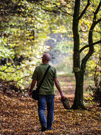 Rear view of man standing in forest