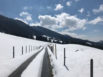 Scenic view of snow covered mountains against sky