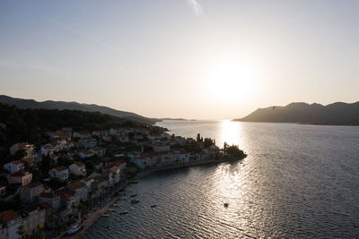 Panoramic view of townscape by sea against clear sky