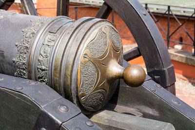 Close-up of old wheel by building