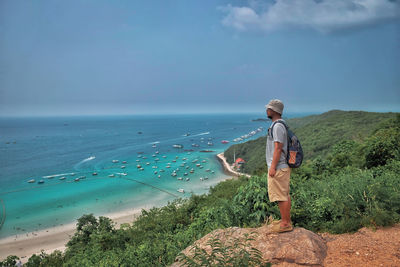 Man standing on beach against sky