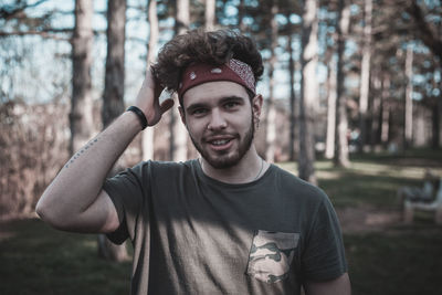 Portrait of young man standing on field