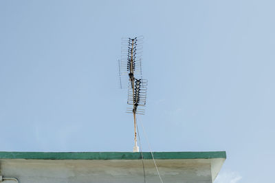 Low angle view of telephone pole against clear sky