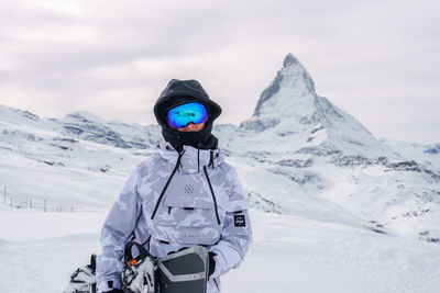 Portrait of woman skiing on snowcapped mountain