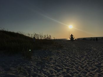 Scenic view of beach against sky during sunset