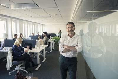 Portrait of team leader standing in office