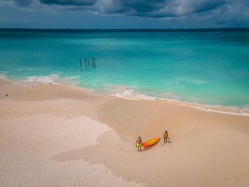 People on beach against sky