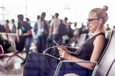 Rear view of woman using mobile phone