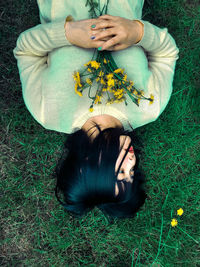 High angle view of woman lying down on field