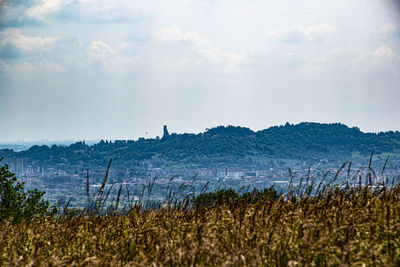 Scenic view of hills and village against sky