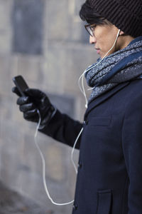 Handsome man with smartphone on street