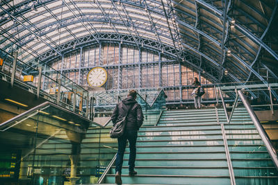 Rear view of woman walking on staircase