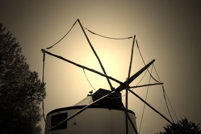 Low angle view of traditional windmill against sky