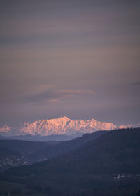 Scenic view of snowcapped mountains against sky during sunset