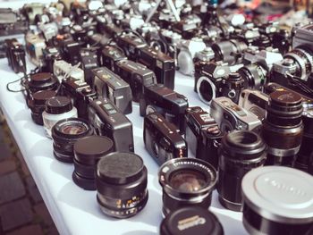 Close-up of analog vintage cameras for sale on flea market