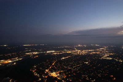 High angle view of illuminated buildings against sky at night