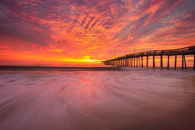 View of bridge over sea against cloudy sky