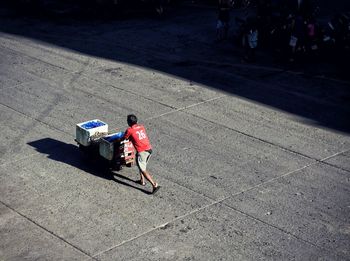 High angle view of people walking on road