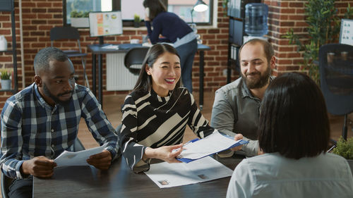 Smiling business colleagues working in office