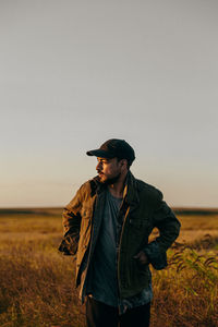 Portrait of a man in a field at sunset