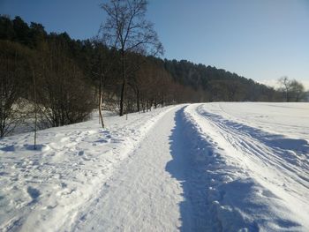 Snow covered field against sky