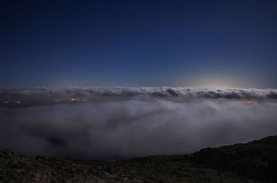 Scenic view of mountains against clear blue sky at night