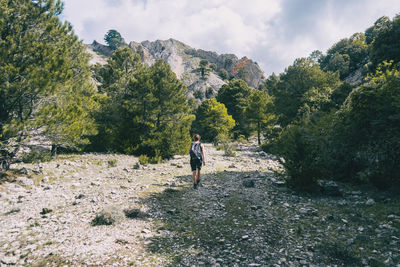 Woman hiking on a mountain path in catalonia on a cloudy summer day