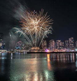 Firework display over city at night