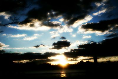 Silhouette of landscape against cloudy sky