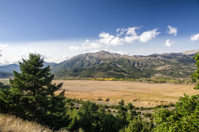 Scenic view of landscape and mountains against sky