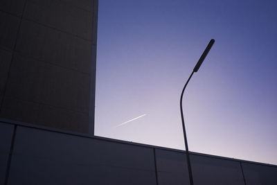 Low angle view of vapor trails against clear sky