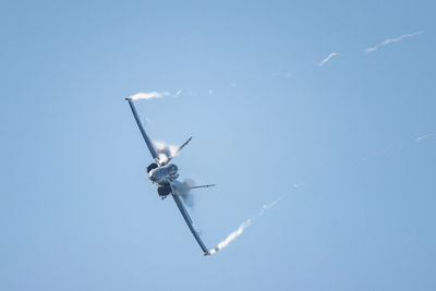 Low angle view of airplane flying in sky