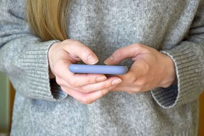 Midsection of woman using mobile phone