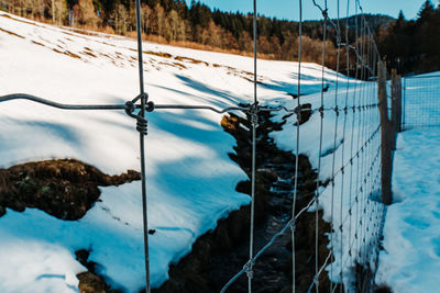 High angle view of metal fence during winter